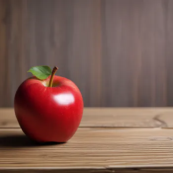 A red apple on a wooden table